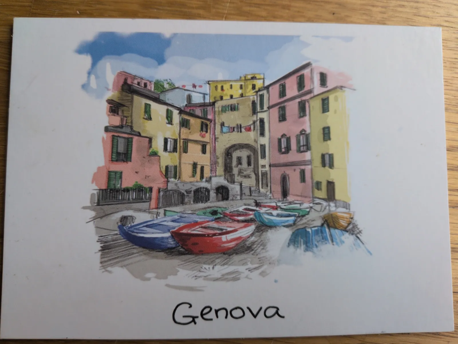 Eine farbenfrohe Aquarell-Ansicht von Genova mit bunten Häusern und kleinen Booten im Vordergrund.