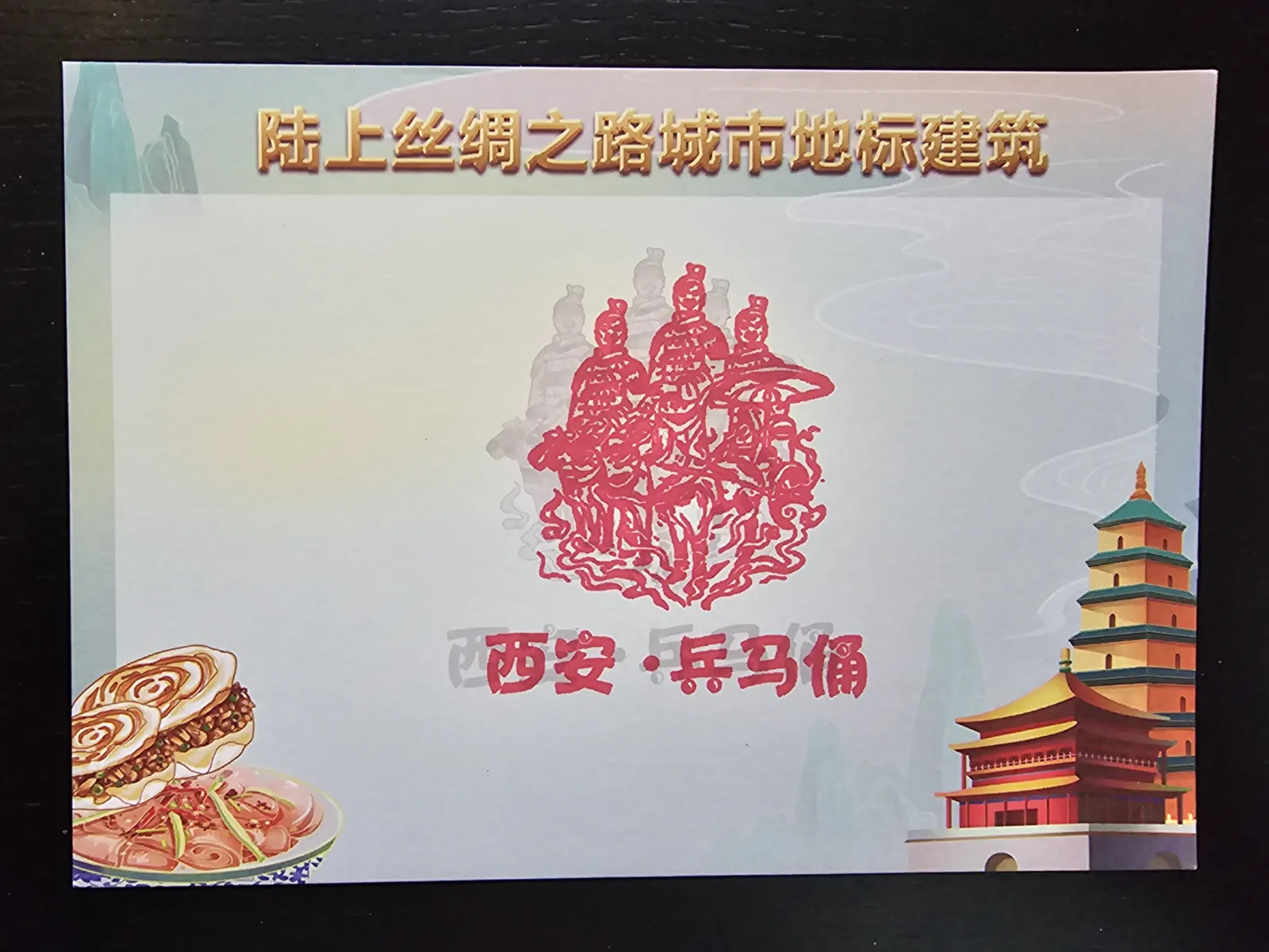 Eine farbige Illustration zeigt stilisierte rote Terrakotta-Krieger im Zentrum, umgeben von traditioneller chinesischer Architektur und Speisen, mit den chinesischen Schriftzeichen für „Xi’an“ und „Terrakotta-Krieger“.