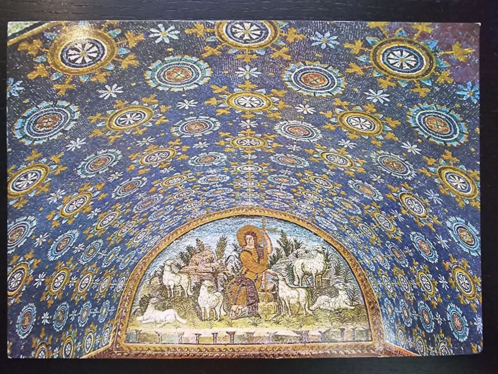 Ein farbenprächtiges Mosaik zeigt eine dunkelblaue Gewölbedecke voller goldener Sterne und Ornamente, darunter eine Szene mit einem Hirten und Schafen.