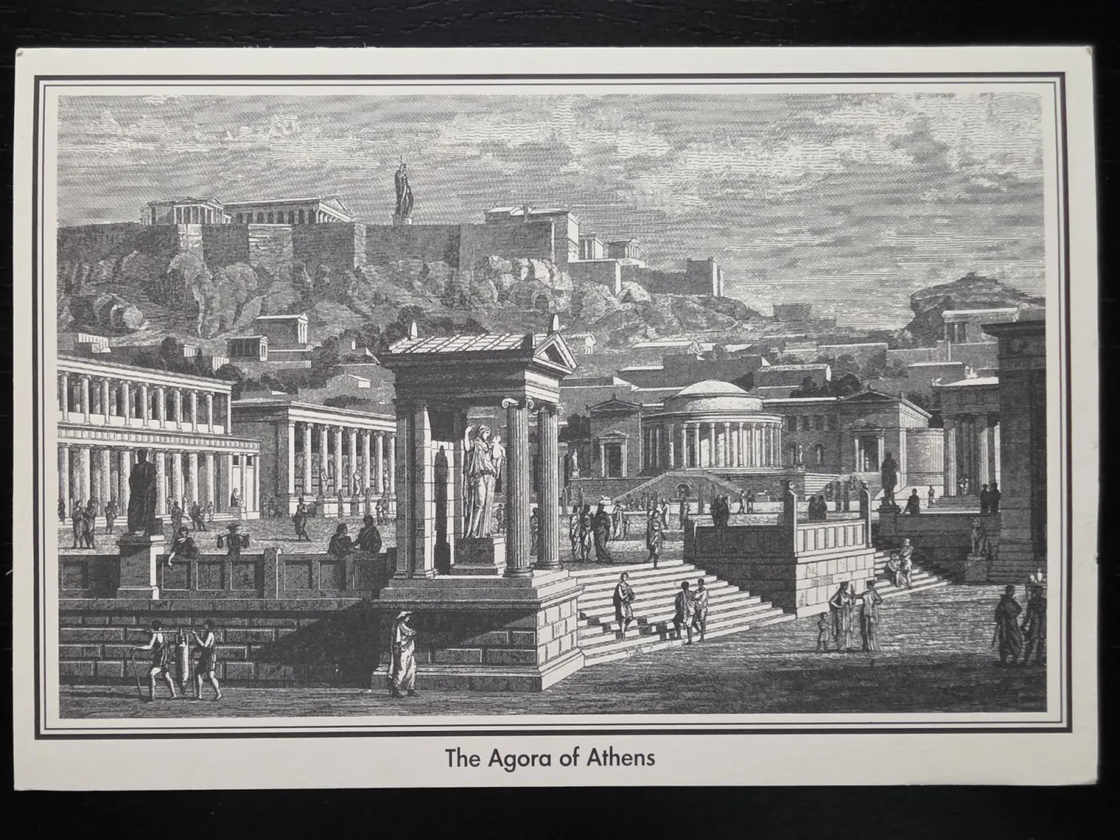Eine historische Schwarz-Weiß-Illustration zeigt die belebte antike Agora von Athen mit ihren Tempeln, Säulenhallen und Statuen, überragt von der Akropolis im Hintergrund.